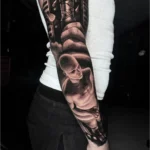 Full sleeve black and grey realism tattoo with biomechanical design and human figure at Inknation Studio NYC
