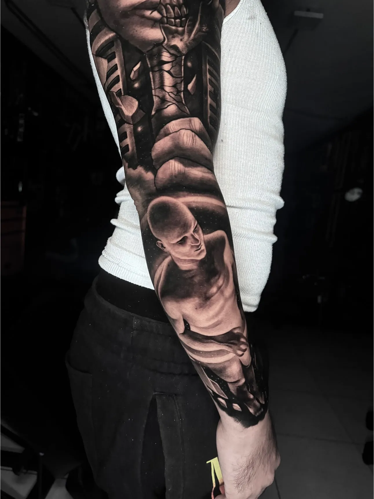 Full sleeve black and grey realism tattoo with biomechanical design and human figure at Inknation Studio NYC