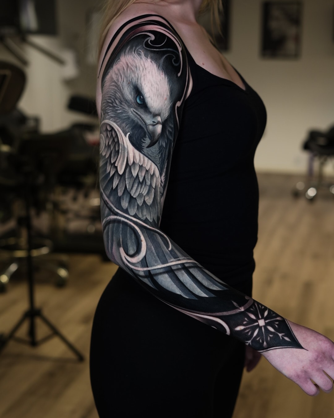 Full sleeve black and grey realism tattoo of an eagle on female arm at Inknation Studio NYC