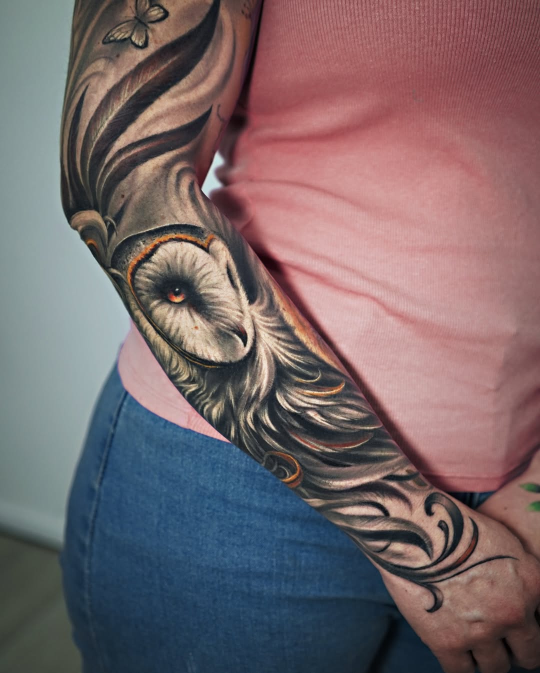 Black and grey realism barn owl upper arm tattoo with orange eyes, wisdom symbolism, Inknation Studio NYC