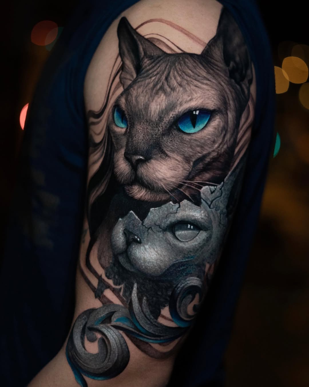 Black and grey realism sphynx cat shoulder tattoo with blue eyes and cracked overlay, mystery symbolism, Inknation Studio NYC
