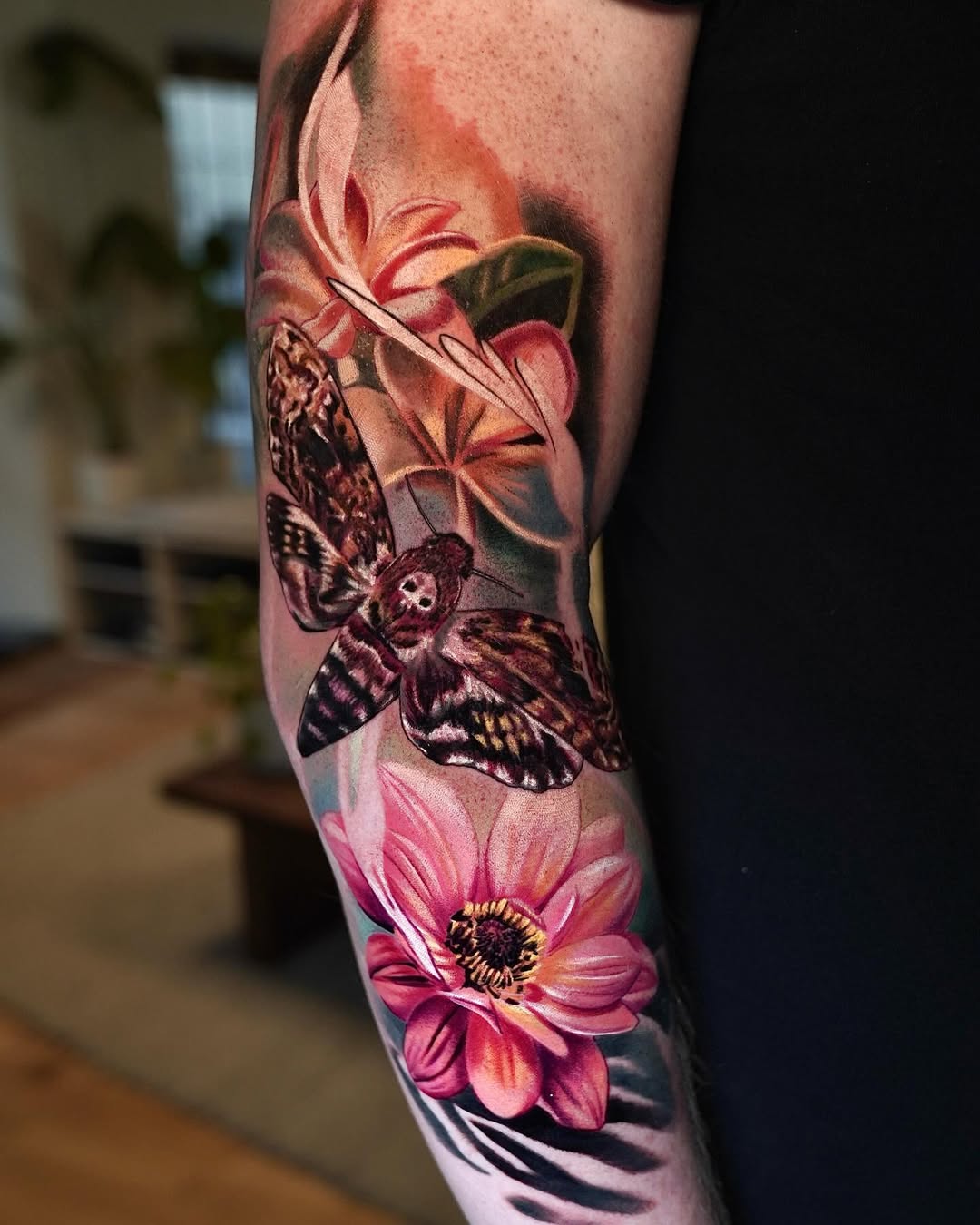 Colorful realism death head moth tattoo with flowers and skull on forearm, moth tattoo meaning transformation, Inknation Studio