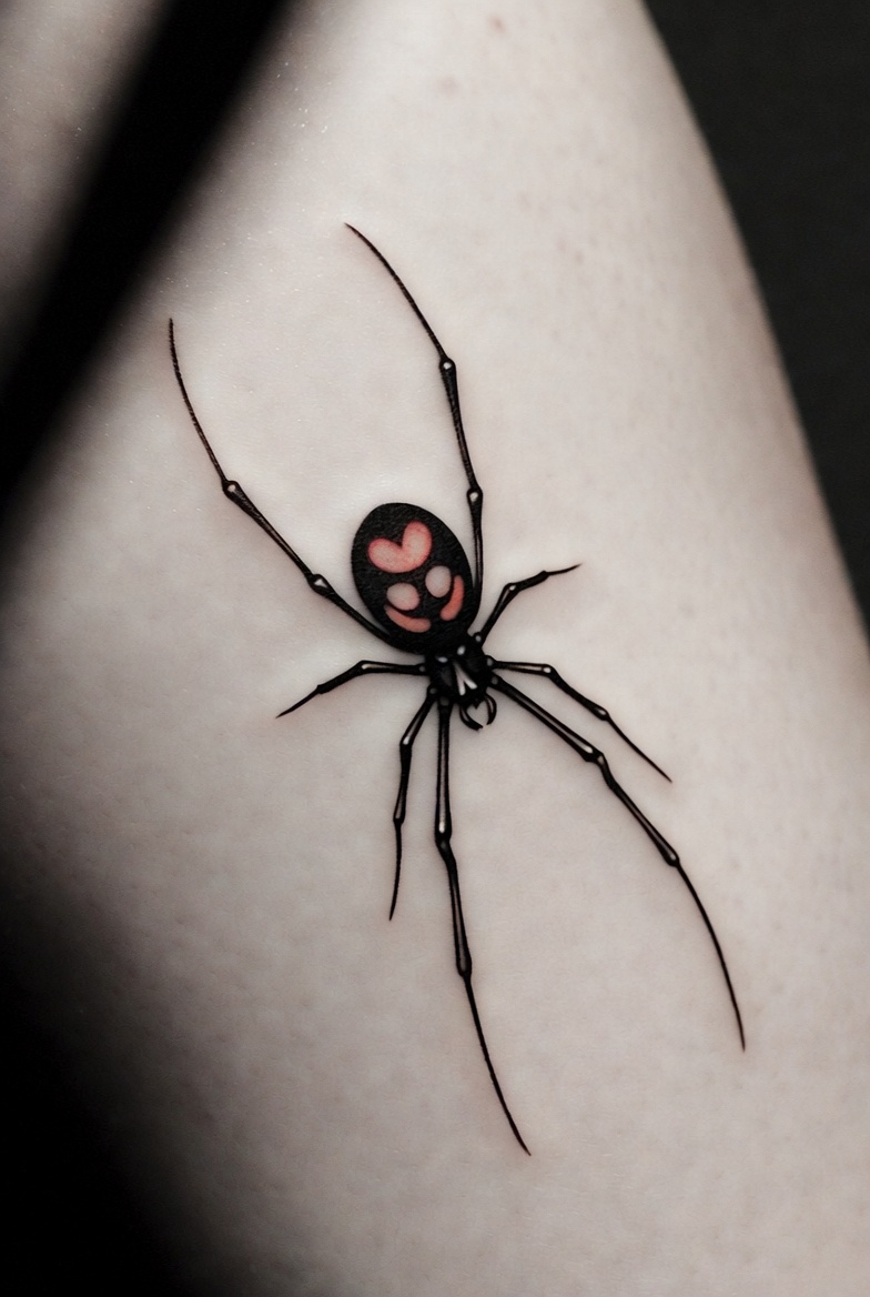 Small black widow spider tattoo with red heart on leg, minimalist black ink, Inknation Studio