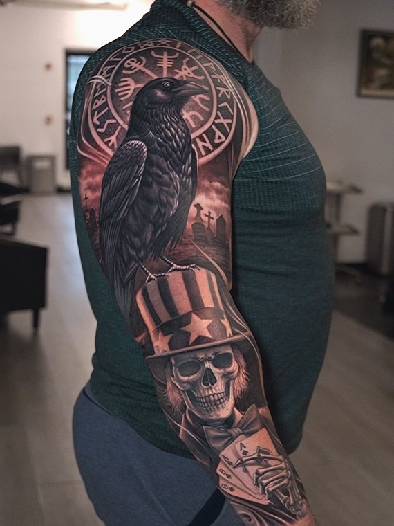 Realistic black and grey raven tattoo sleeve with skull in American hat, graveyard, and runes | symbolic mortality and rebirth, Inknation Studio NYC