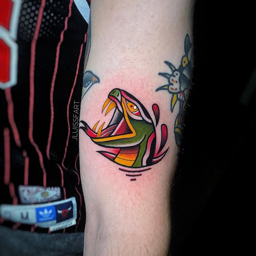 Traditional Japanese snake tattoo on forearm with flames and open mouth, Inknation Studio NYC
