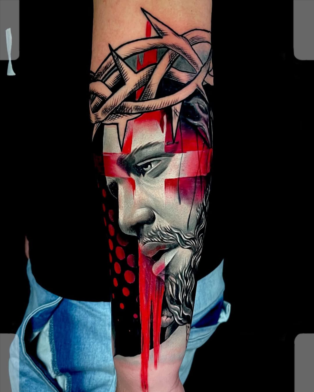 Trash polka tattoo sleeve featuring realistic Christ portrait with bold black and red graphic elements at Inknation Studio NYC