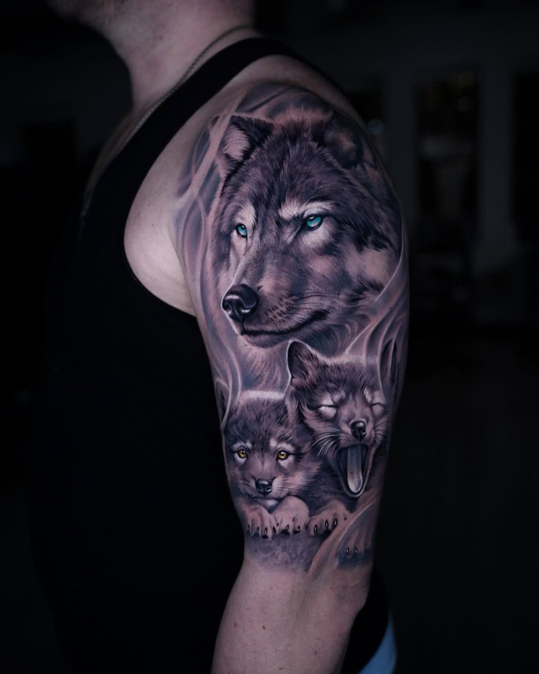 wolf family tattoo black grey realism upper arm.jpg tattoo by Inknation Studio NYC.realism-tattoo-arm